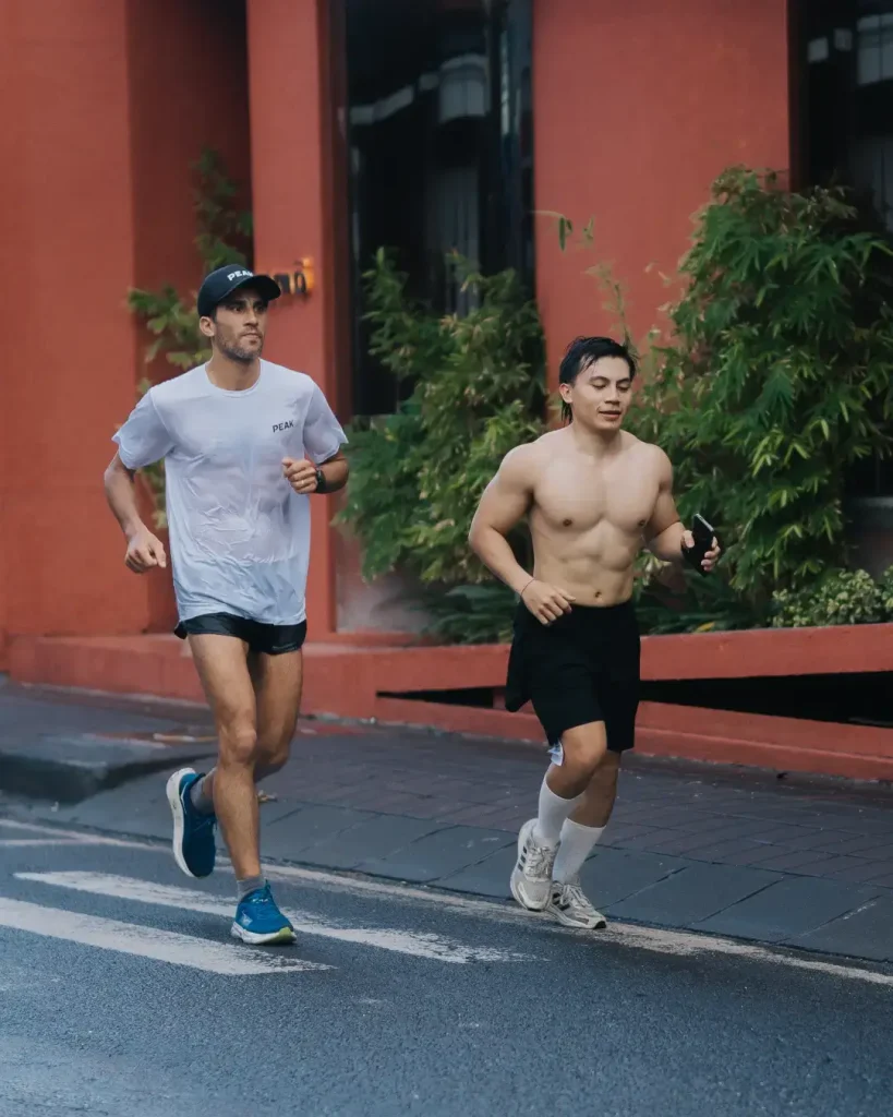 Two male participants running during the Avenue Running Club 6K run through the streets of Canggu on May 25.