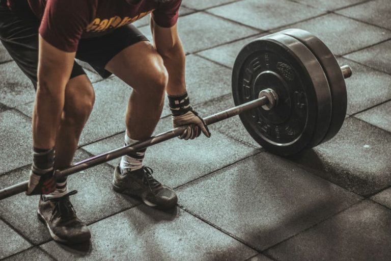 A person performing a heavy deadlift at a premier gym in Canggu Bali, highlighting fitness for digital nomads.