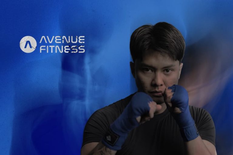 Professional athlete in a boxing stance with blue hand wraps for boxing & muay thai class canggu.