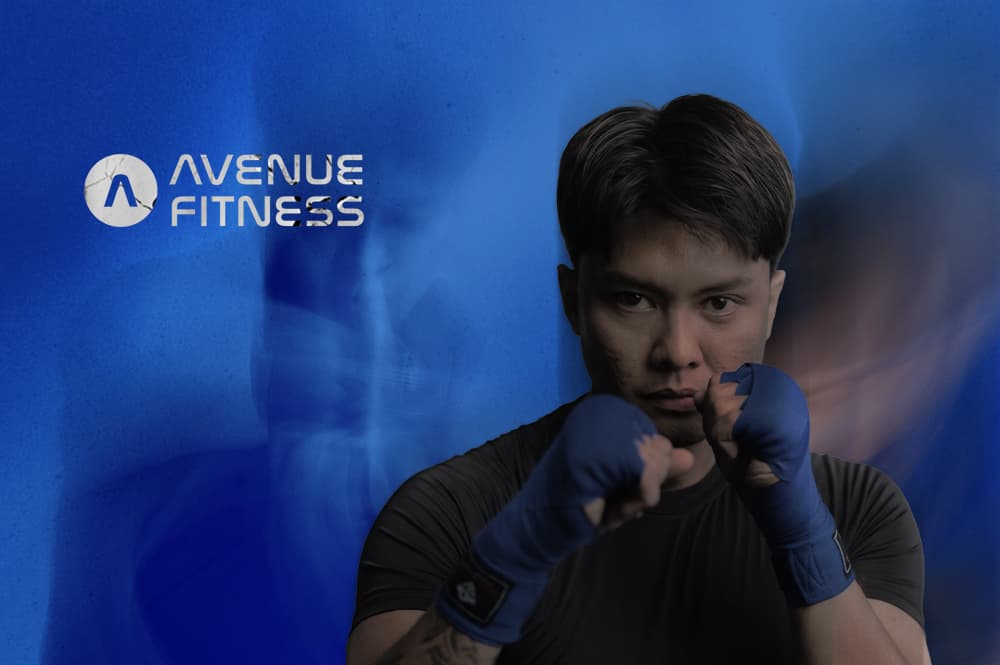 Professional athlete in a boxing stance with blue hand wraps for boxing & muay thai class canggu.